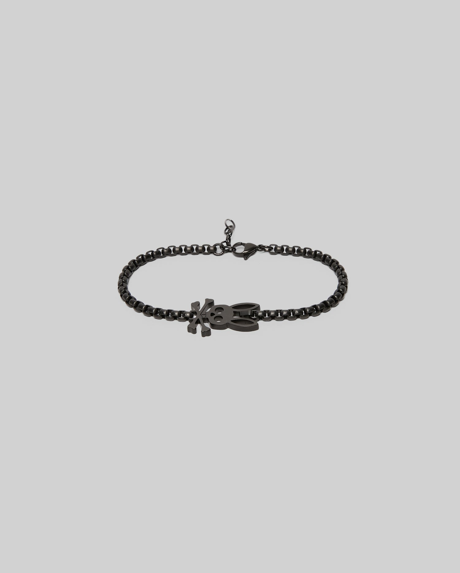 The Psycho Bunny MENS BUNNY BRACELET - MO1700018 features a black chain, a lobster clasp, and an "XO"-shaped pendant for timeless style, shown against a light gray background.