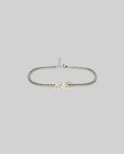 The Psycho Bunny MENS BUNNY BRACELET - MO1700018 is a silver steel piece with a lobster clasp and hand-shaped charm, showcased on a light gray background for classic appeal.