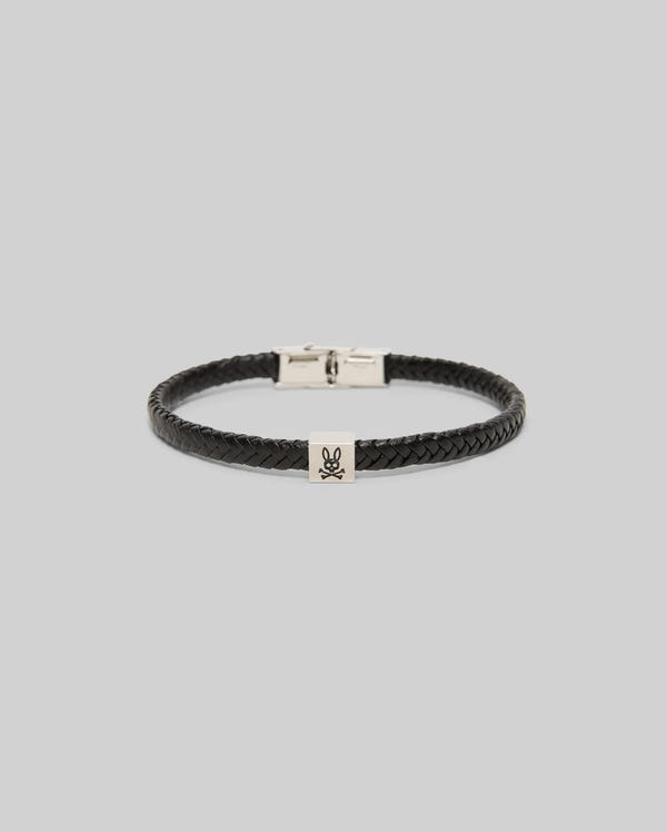 The Psycho Bunny MENS LEATHER BRAIDED BRACELET - MO1700020 features black braided leather, a hinged silver clasp, and a square charm engraved with a bunny logo, shown on a light gray background.