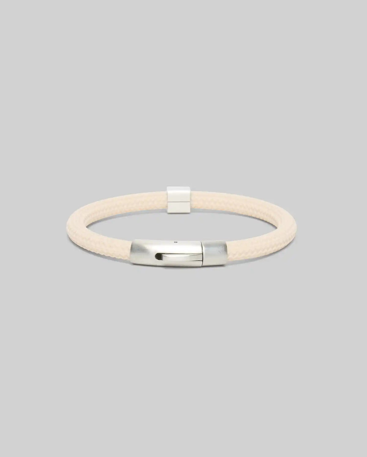 Mens Silicone Bracelet, a premium streetwear accessory, featuring a cream-colored braided silicone band and a polished silver metallic clasp, embodying refined style.