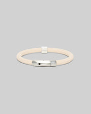 Mens Silicone Bracelet, a premium streetwear accessory, featuring a cream-colored braided silicone band and a polished silver metallic clasp, embodying refined style.