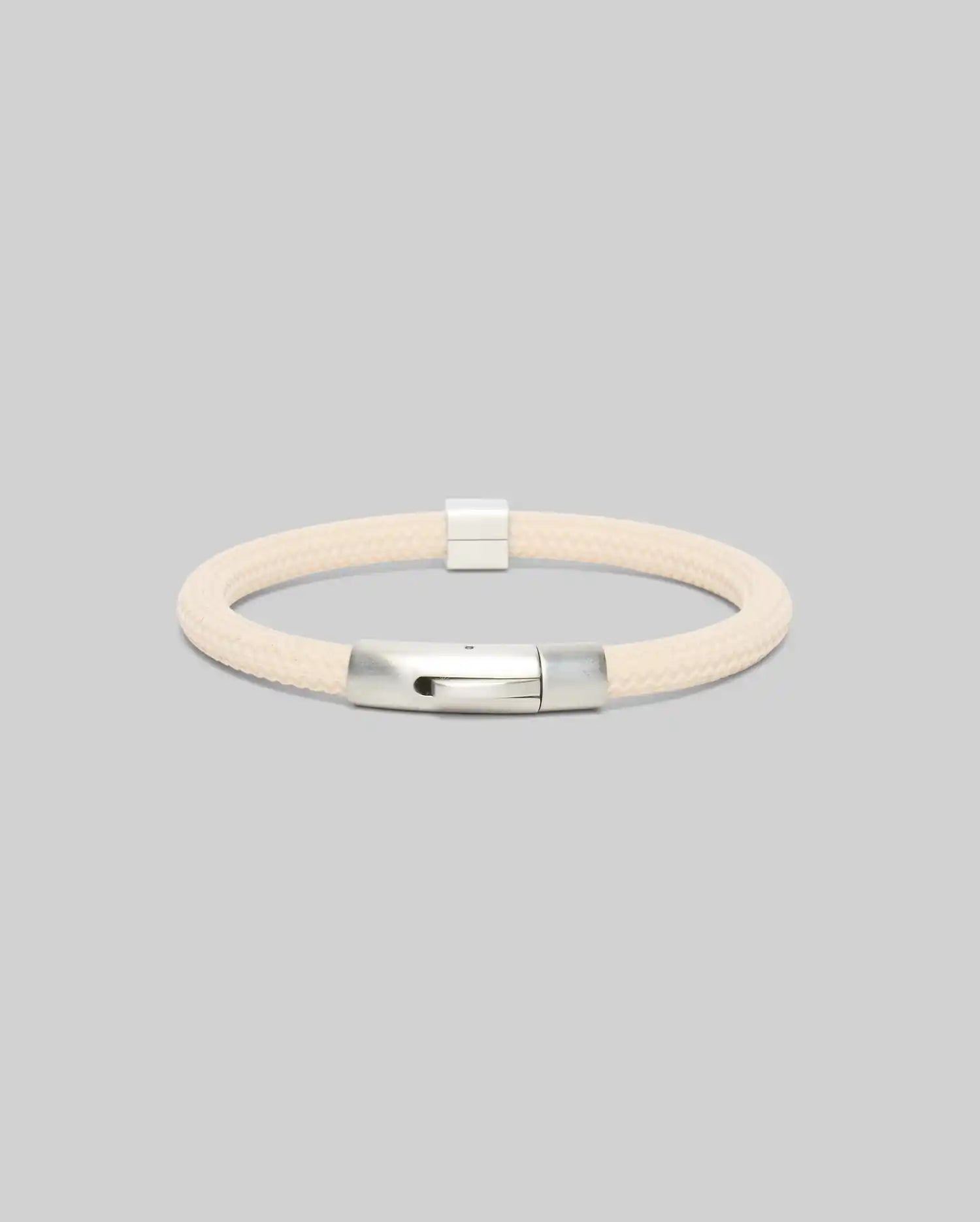 Mens Silicone Bracelet, a premium streetwear accessory, featuring a cream-colored braided silicone band and a polished silver metallic clasp, embodying refined style.