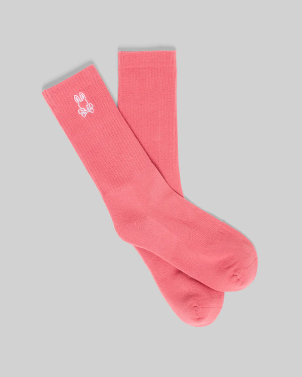 A pair of Psycho Bunny MENS NEW CLASSIC SPORT SOCK - MO2200001 in pink Pima cotton, shown on a light gray background, features a small white embroidered logo near the top for a comfortable, classic look.
