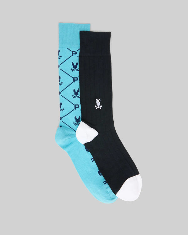 The Psycho Bunny MENS 2 PACK DRESS SOCK (MO2200005) includes a teal pair with black diamonds, leaves, and a "P" motif, plus a black pair with a white bunny face and contrasting toe and heel.