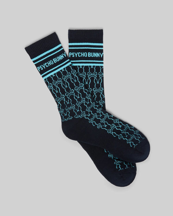 Mens Kace Sport Sock in navy blue with light blue stripes and Psycho Bunny text on the ribbed cuff, featuring an all-over light blue bunny skull logo pattern.