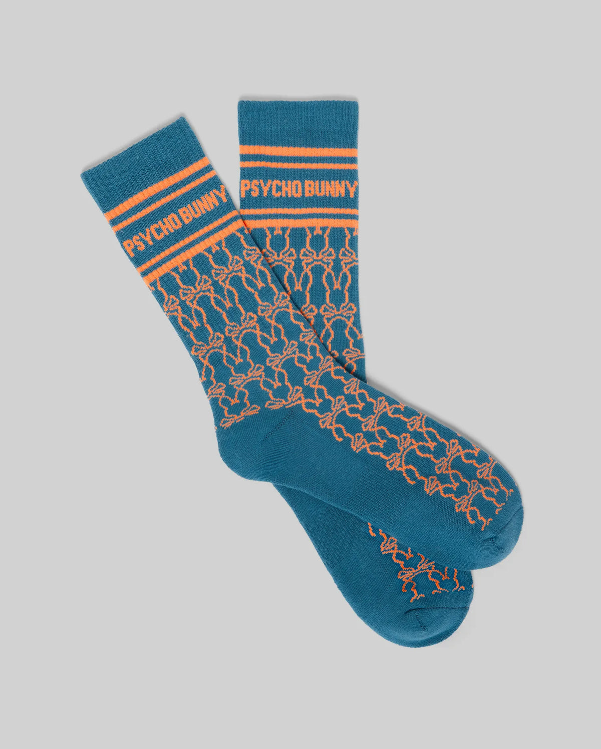 Mens Kace Sport Sock in teal knit, featuring orange Psycho Bunny text on the ribbed cuff with two stripes, and an all-over repeating orange bunny skull logo pattern.
