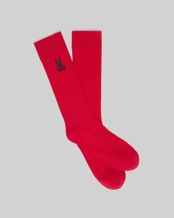 Mens Evander Waffle Sport Sock in vibrant red, featuring a small black embroidered Psycho Bunny skull logo on the outer calf and a subtle ribbed knit texture.