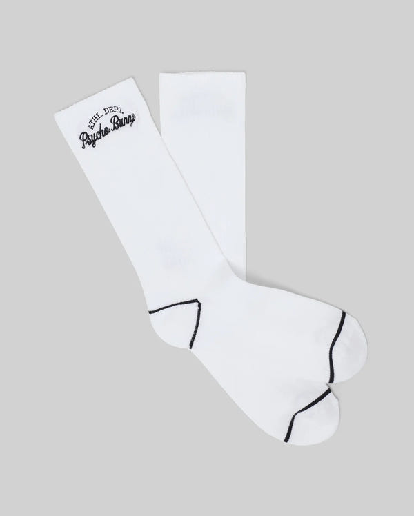 The Psycho Bunny MENS SCPRIT SOCKS (MO2200035) are white sport socks made from soft Pima cotton, featuring black accents on the toes and heels and "Psycho Bunny" text near the top, shown on a light gray background.
