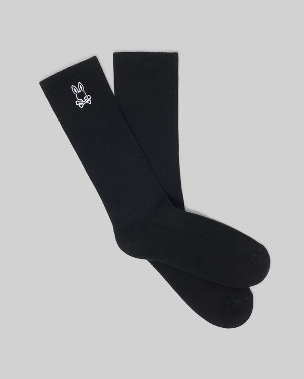 The Psycho Bunny MENS 2 PACK SPORT SOCK - MO2200037 features black cotton crew socks with a white bunny logo near the top. Durable and stylish, they're ideal for everyday comfort, shown here on a light gray background.