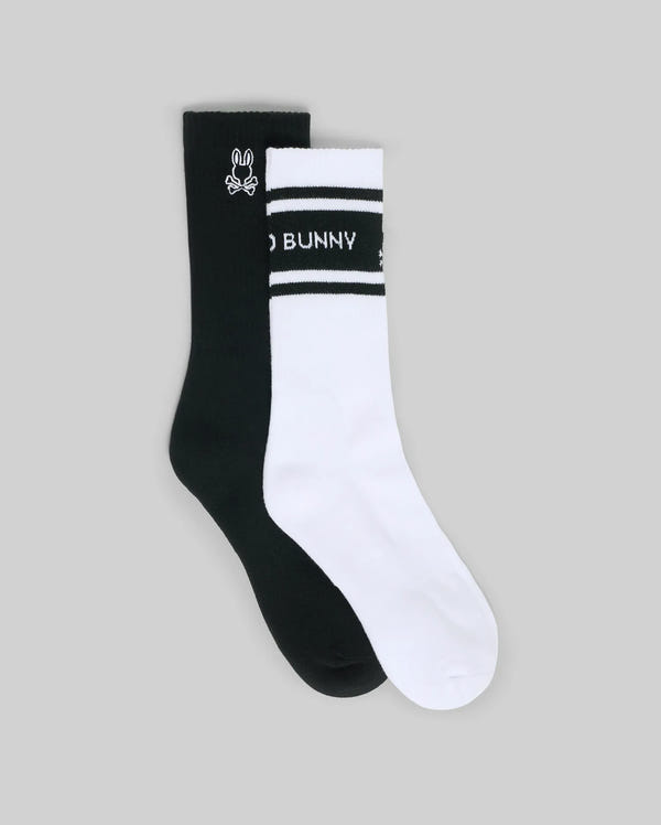 The Psycho Bunny MENS 2 PACK SPORT SOCK (MO2200037) features one black crew sock with a white bunny logo and one white crew sock with black stripes and "BUNNY" on the band—durable cotton for comfort and style.
