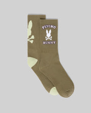 Psycho Bunny MENS 2PK BUNNY SPORT SOCK (MO2200038) features olive green socks with light green toe and heel, a white skull and bunny logo, "Psycho Bunny" text in white/pink on the sides, crafted from soft Pima cotton.