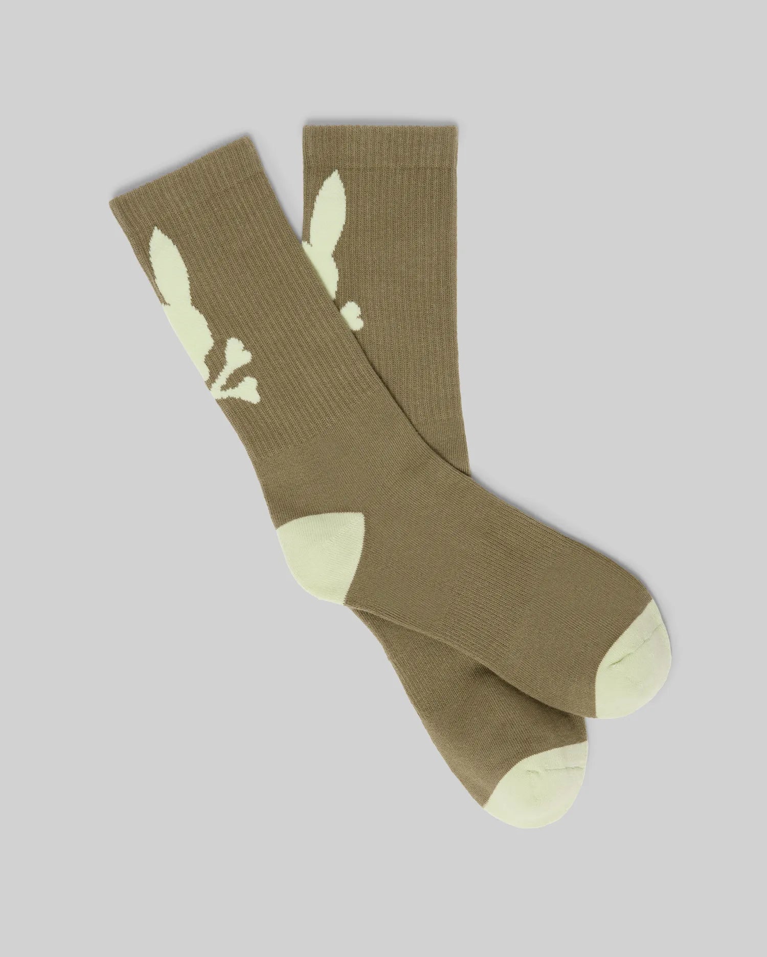 The Psycho Bunny MENS 2PK BUNNY SPORT SOCK - MO2200038 features brown athletic socks with white toe and heel accents and a white bunny logo on the sides, displayed on a light gray background.