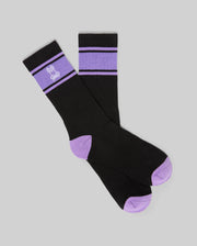 Mens Striped Sport Sock in black knit, featuring purple ribbed cuffs with two black stripes, a white embroidered Psycho Bunny skull logo, and purple contrast heels and toes.