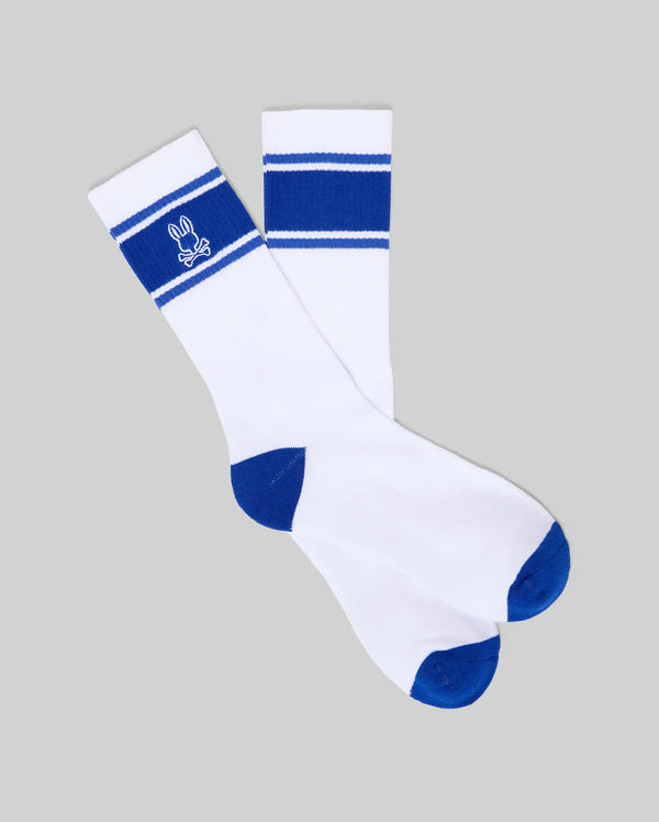 Mens Striped Sport Sock, white athletic crew socks with bold royal blue stripes, toe, and heel. Features a prominent embroidered white Psycho Bunny skull logo on the cuff. Smooth knit fabric.