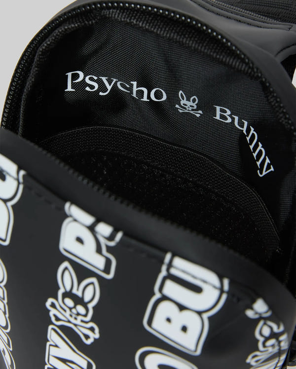 Mens Rubberized Crossbody in black, featuring a prominent white repeating Psycho Bunny skull logo and text pattern on its smooth exterior, complemented by a black interior lining with white Psycho Bunny branding.