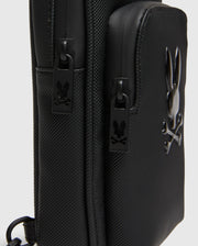 Black Crossbody Bag with durable textured fabric, featuring a prominent glossy raised Psycho Bunny skull logo and custom black zipper pulls with the logo. (3)