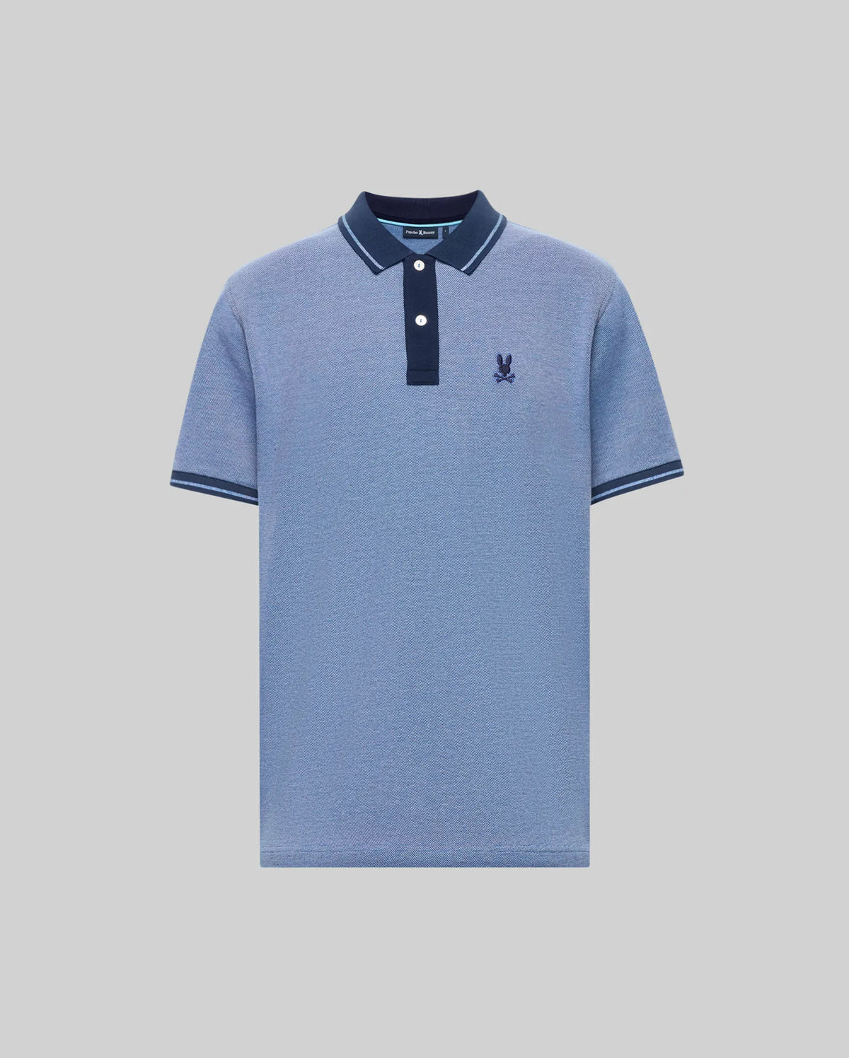 The Psycho Bunny QUINTON TEXTURE PIQUE POLO features light blue short sleeves, a dark blue collar and button placket with white buttons, dark blue sleeve trim, and a dark blue embroidered logo on the left chest.