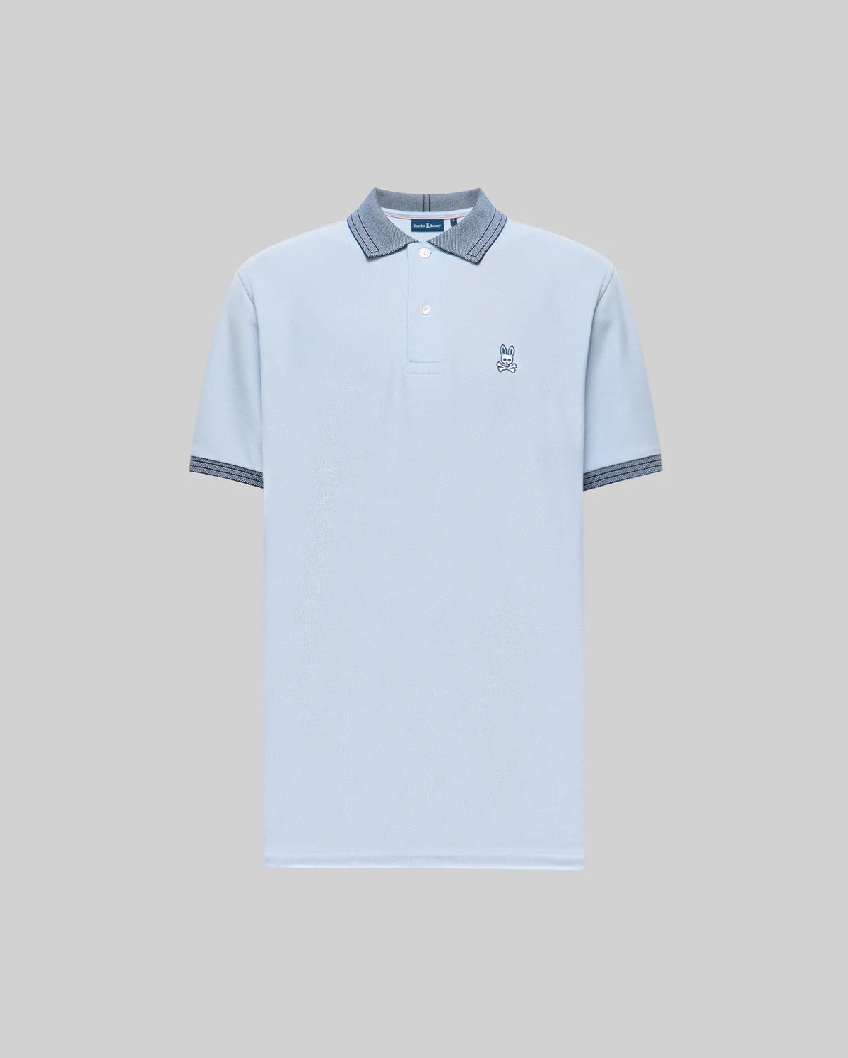 The Psycho Bunny MENS MURPHY PIQUE POLO SHIRT (MT0100026) is a light blue Pima cotton polo with contrast blue and gray striped collar and cuffs, plus a small Bunny logo on the chest, shown against a plain gray background.