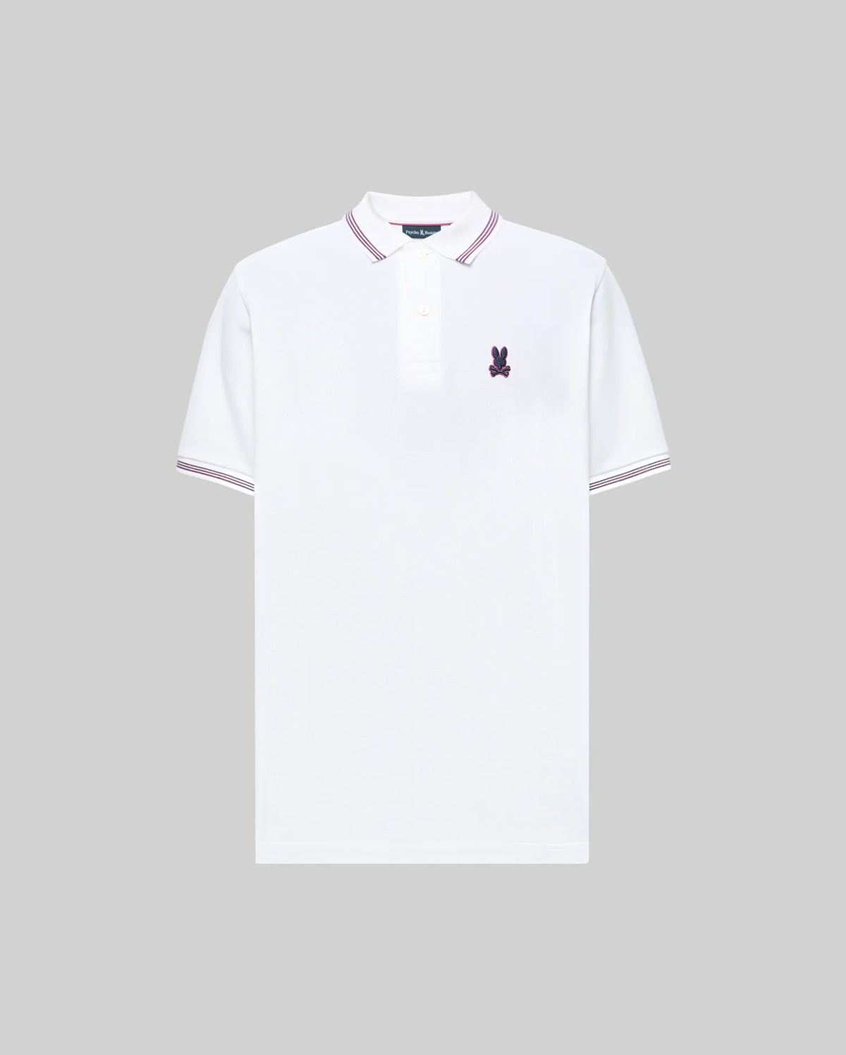 The Psycho Bunny MENS HART PIQUE POLO SHIRT (MT0100032) is a white Pima cotton polo with purple collar and sleeve trim, buttoned placket, and a small purple bunny logo on the chest, shown on a gray background.