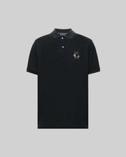 The Psycho Bunny MENS AUGUSTE PIQUE POLO SHIRT - MT0100051 is a black Pima cotton polo with short sleeves, a collar, three buttons, and an embroidered white rabbit logo on the left chest, shown on a plain light gray background.