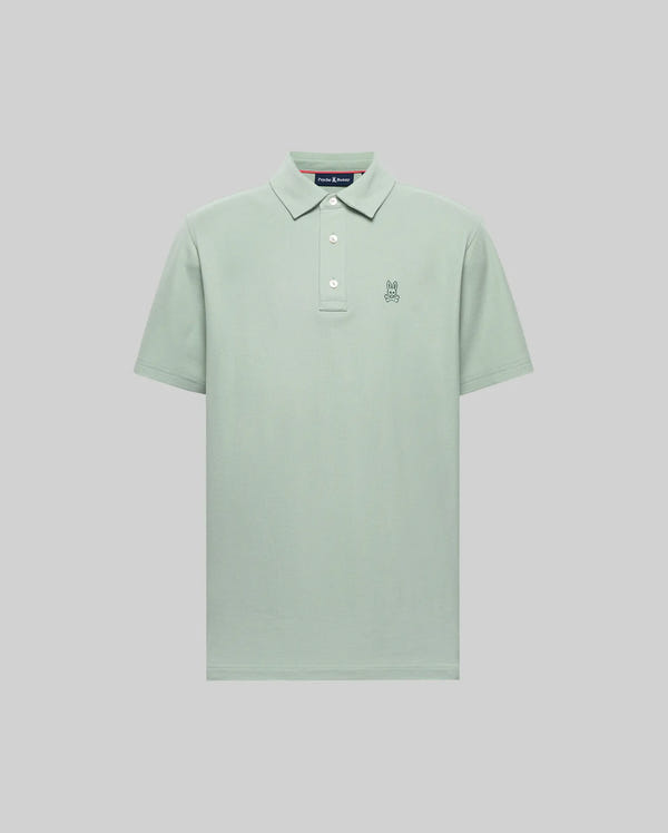 The Psycho Bunny MENS PHOENIX FASHION POLO (MT0100096) is a light green, short-sleeve Pima cotton shirt with a collar, three buttons, and a small embroidered bunny logo on the left chest, shown on a plain gray background.