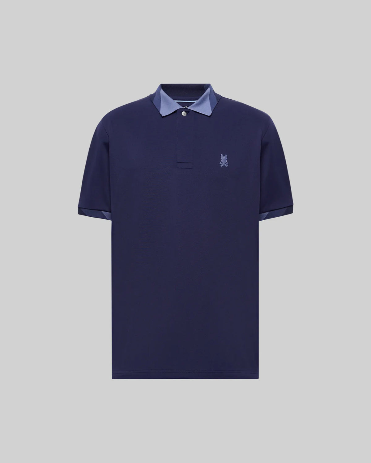 Mens Onyx Sport Polo, a classic fit dark navy pique polo shirt featuring a tonal embroidered Psycho Bunny skull logo on the left chest and contrasting light blue trim on the collar and sleeve cuffs.