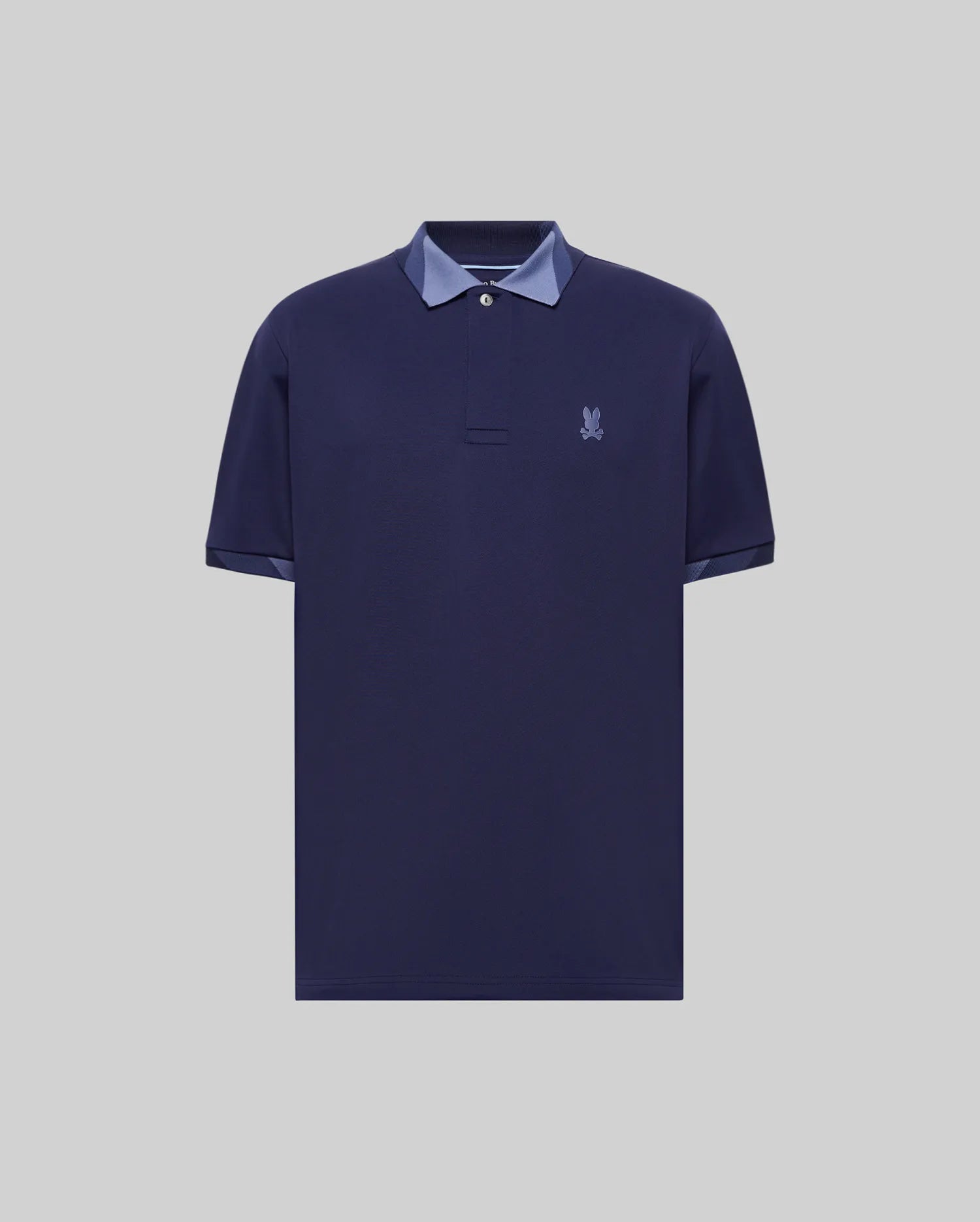 Mens Onyx Sport Polo, a classic fit dark navy pique polo shirt featuring a tonal embroidered Psycho Bunny skull logo on the left chest and contrasting light blue trim on the collar and sleeve cuffs.