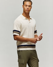 Mens Lochlan Oversized Johnny Collar Polo in cream waffle knit, featuring a relaxed fit, open collar, and striped short sleeves and hem with navy and olive accents.