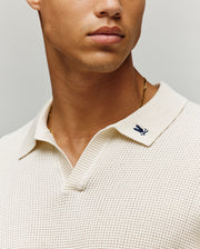 Mens Lochlan Oversized Johnny Collar Polo in cream textured knit, featuring a small embroidered dark blue Psycho Bunny skull logo on the left collar.