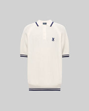 The Psycho Bunny MENS LAZARE KNIT POLO (MT0100165) is a short-sleeved, off-white textured polo with navy stripes on the collar, sleeves, and hem, a buttoned placket, and an embroidered bunny crest on the chest. Shown on a gray background.