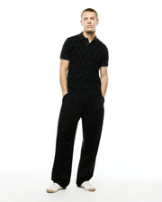 Men's Angus Flocked Polo: Black classic fit pique polo with a refined streetwear aesthetic, showcasing an all-over tonal flocked geometric bunny skull pattern and a two-button placket. (4)