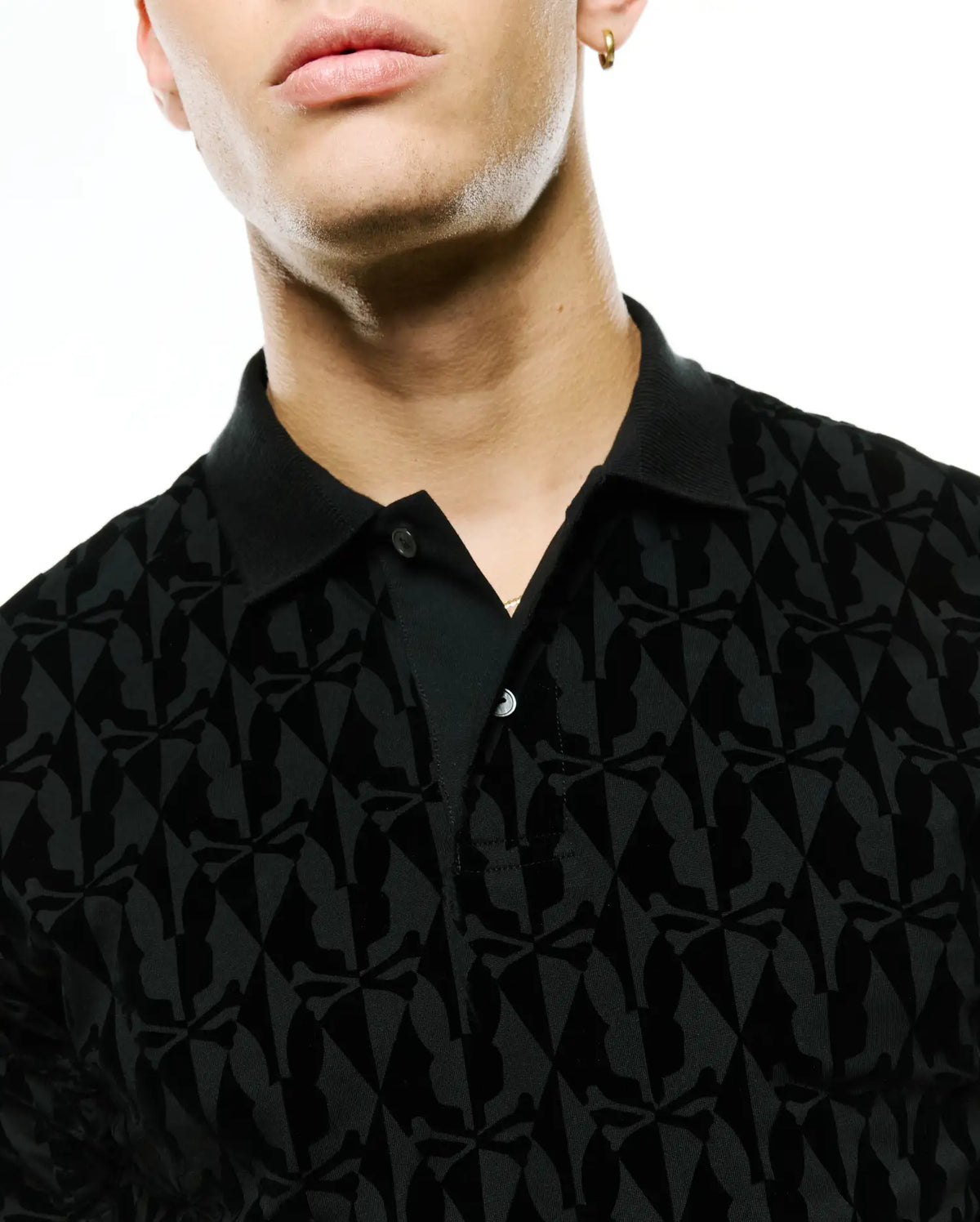 Men's Angus Flocked Polo, black classic fit pique polo featuring a tonal velvet-flocked all-over Psycho Bunny skull and crossbones pattern, complete with a two-button placket. (2)