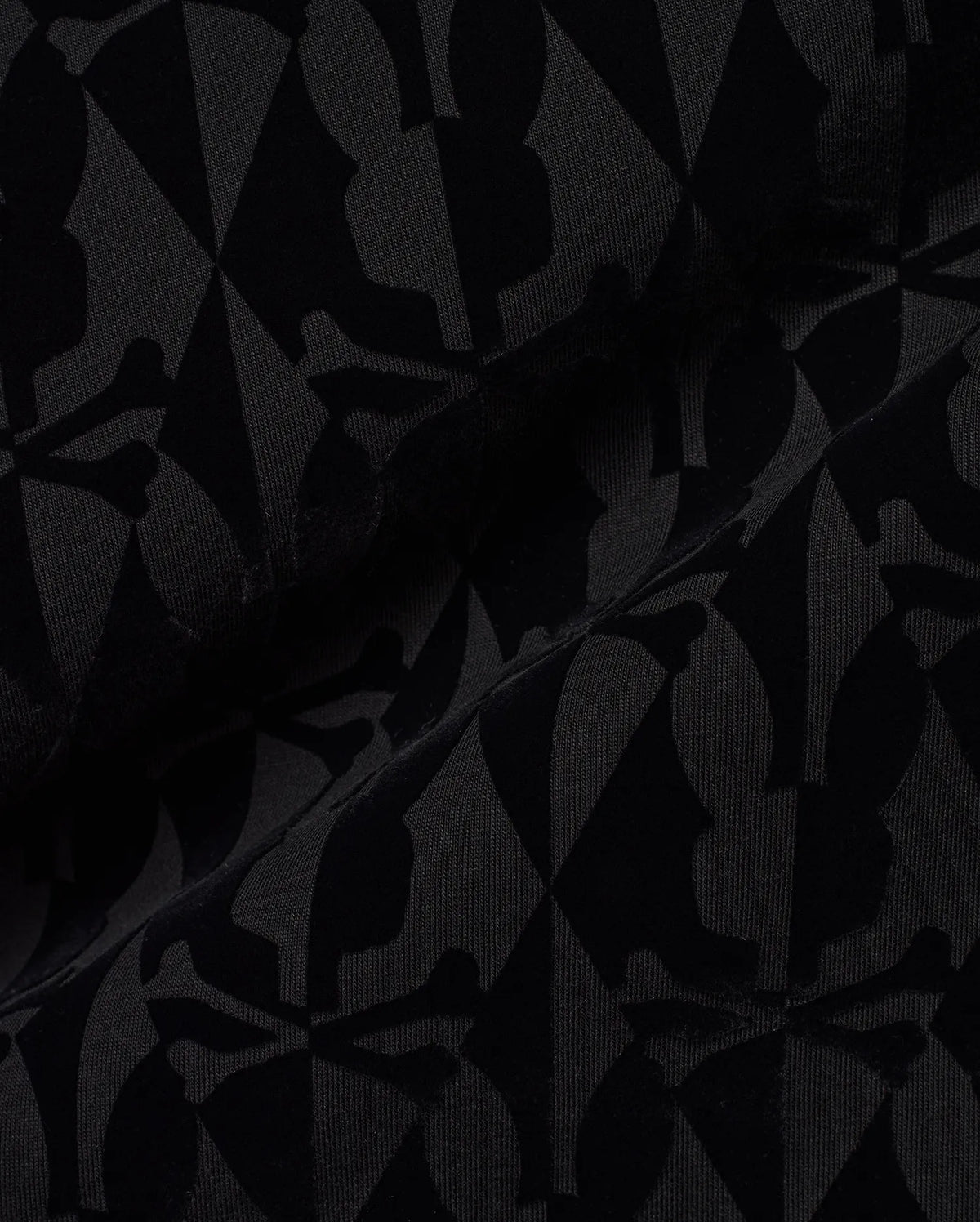 Men's Angus Flocked Polo featuring a tonal black flocked Psycho Bunny skull and crossbones and diamond pattern on a black pique knit fabric. (6)
