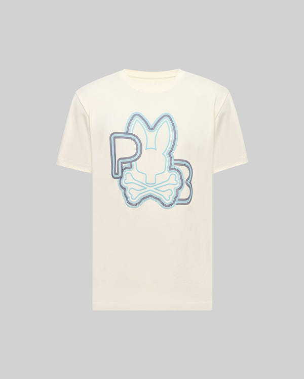 The Psycho Bunny MENS CARLO GRAPHIC TEE (MT0200049) is a cream Pima cotton jersey shirt with a bold blue and purple bunny and crossed bones graphic, plus "P" and "B" lettering, shown on a plain gray background.