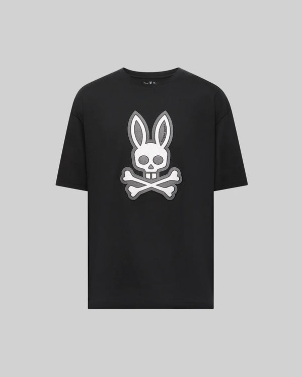 The Psycho Bunny MENS RYDER OVERSIZED TEE (MT0200062) is a black premium Pima cotton shirt with a bold white bunny head and long ears over a skull and crossbones graphic, displayed on a plain light gray background.