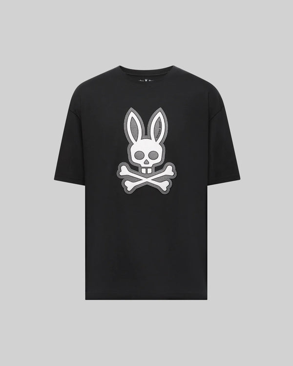 The Psycho Bunny MENS RYDER OVERSIZED TEE (MT0200062) is a black premium Pima cotton shirt with a bold white bunny head and long ears over a skull and crossbones graphic, displayed on a plain light gray background.