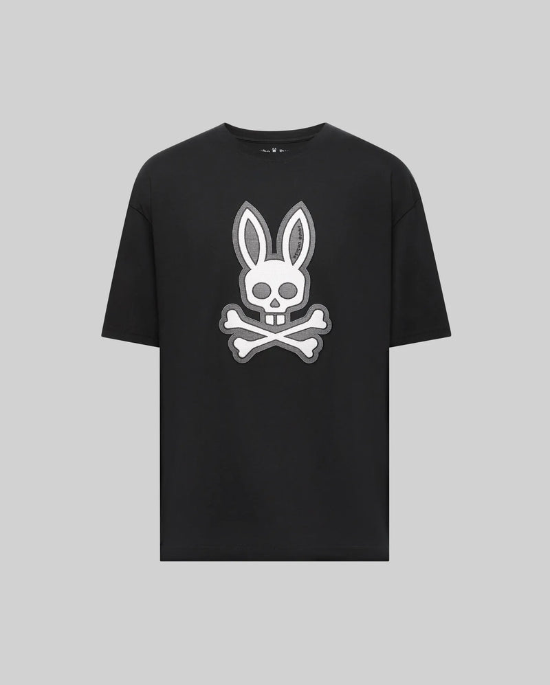 The Psycho Bunny MENS RYDER OVERSIZED TEE (MT0200062) is a black premium Pima cotton shirt with a bold white bunny head and long ears over a skull and crossbones graphic, displayed on a plain light gray background.