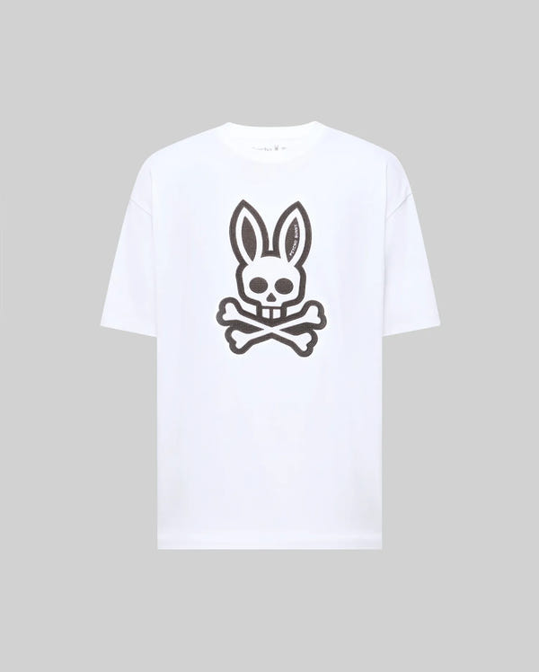 The Psycho Bunny MENS RYDER OVERSIZED TEE (MT0200062) features a bold black skull with bunny ears and crossed bones graphic on premium white Pima cotton, shown against a plain light gray background.