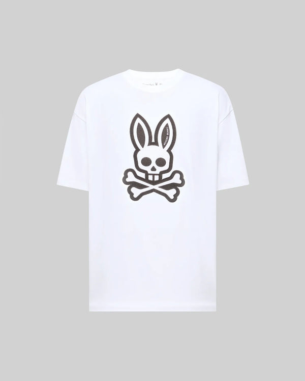 The Psycho Bunny MENS RYDER OVERSIZED TEE (MT0200062) features a bold black skull with bunny ears and crossed bones graphic on premium white Pima cotton, shown against a plain light gray background.