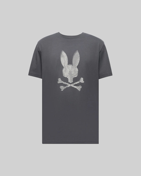 The Psycho Bunny MENS GRANT BUNNY GRAPHIC TEE (MT0200081) is a dark gray Pima cotton tee featuring a white bunny head above crossed bones, creating a playful skull and crossbones design centered on the chest.