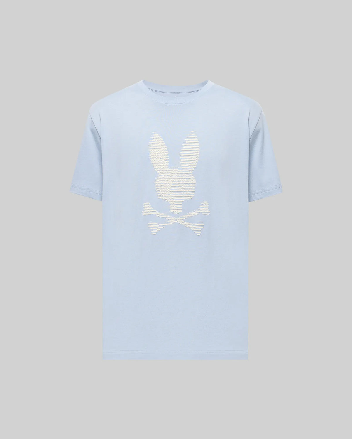 The Psycho Bunny MENS GRANT BUNNY GRAPHIC TEE (MT0200081) features a light blue Pima cotton build with a bold white bunny head over crossed bones graphic on the chest, set against a plain grey background.