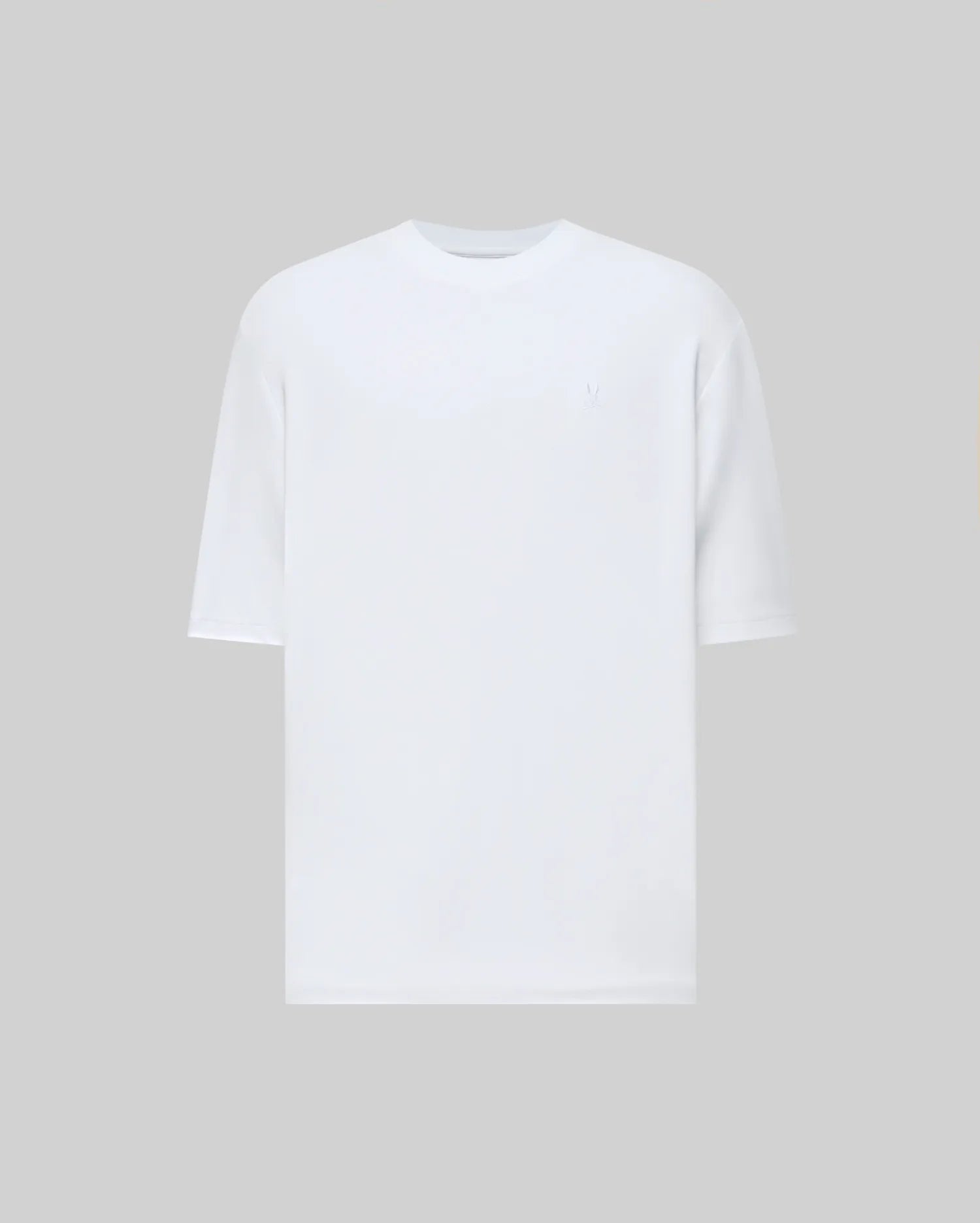 The Psycho Bunny MENS ADAM INTERLOCK TEE (MT0200093) is a plain white men's knit t-shirt with short sleeves, a round neckline, and a subtle embroidered Bunny logo, displayed on a solid light gray background.