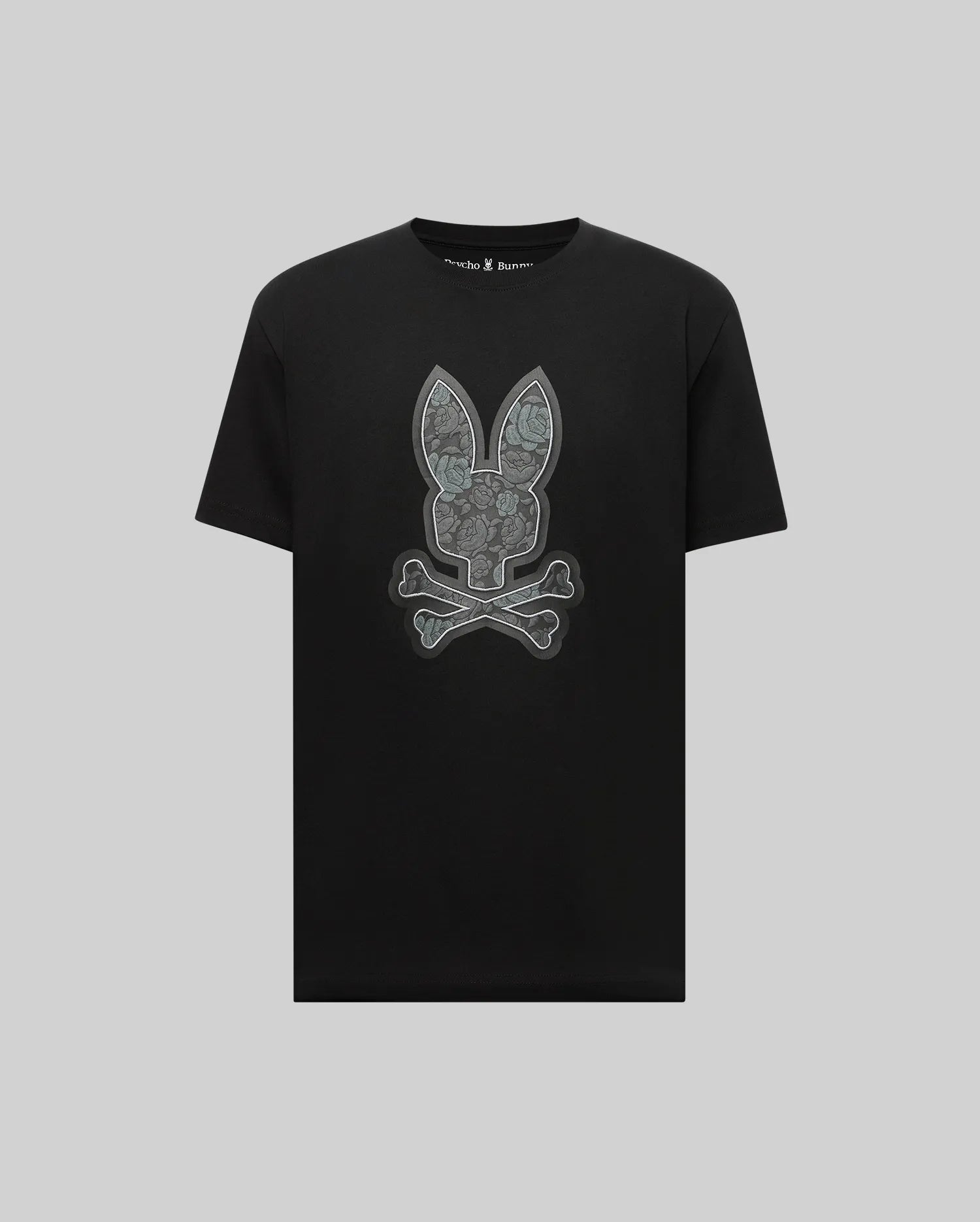 The Psycho Bunny MENS ROWEN BUNNY GRAPHIC TEE - MT0200101 is a black short-sleeve Pima cotton shirt featuring a large gray bunny skull and crossbones graphic on the front.