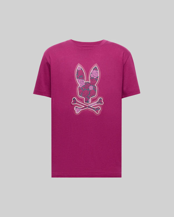 The Psycho Bunny MENS ROWEN BUNNY GRAPHIC TEE - MT0200101 is a magenta Pima cotton shirt with a bunny head, floral patterns, and crossed bones graphic on the chest, set against a plain light grey background.