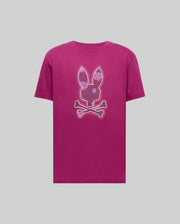 The Psycho Bunny MENS ROWEN BUNNY GRAPHIC TEE - MT0200101 is a magenta Pima cotton shirt with a bunny head, floral patterns, and crossed bones graphic on the chest, set against a plain light grey background.