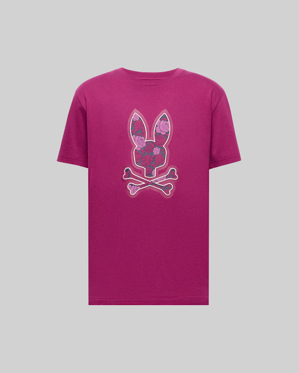 The Psycho Bunny MENS ROWEN BUNNY GRAPHIC TEE - MT0200101 is a magenta Pima cotton shirt with a bunny head, floral patterns, and crossed bones graphic on the chest, set against a plain light grey background.