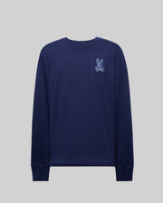 The Psycho Bunny MENS ROWEN GRAPHIC TEE (MT0200103) is a navy crewneck with ribbed cuffs, featuring a small white and light blue embroidered cartoon bunny and crossbones on the left chest, shown against a plain grey background.