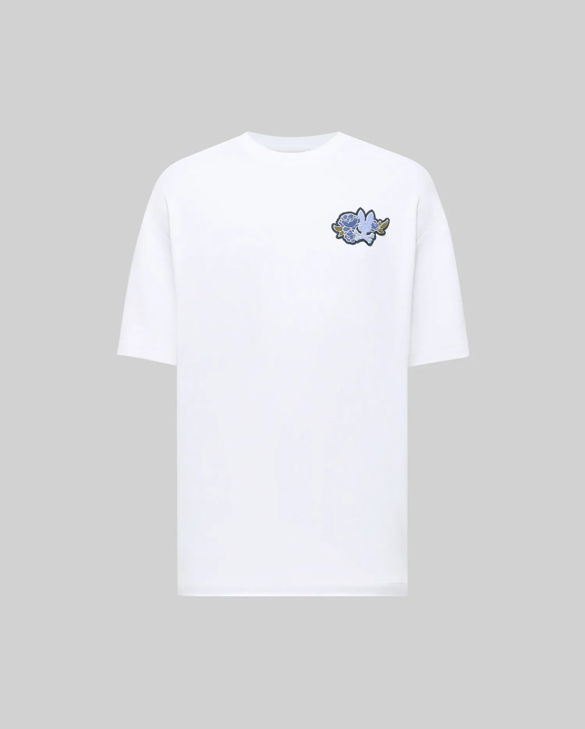 The Psycho Bunny MENS AUGUSTE OVERSIZED TEE (MT0200104) offers a relaxed fit in plain white, highlighted by a small blue rose and white dove graphic on the left chest for effortless laidback style.