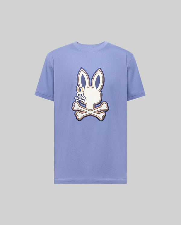The Psycho Bunny MENS WADE GRAPHIC TEE - MT0200106 is a light purple, 100% cotton t-shirt with a large white cartoon bunny head above crossed bones graphic on the chest.