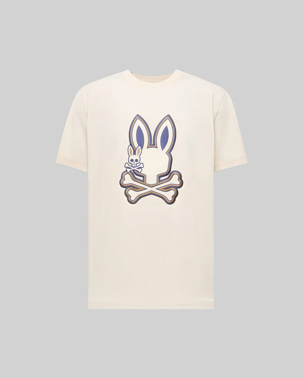 The Psycho Bunny MENS WADE GRAPHIC TEE - MT0200106 is a cream 100% cotton shirt with a bold bunny head and crossed bones graphic on the chest, plus an embroidered Bunny detail inside one ear.